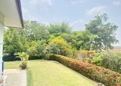 Well-maintained garden area with greenery and clear skies