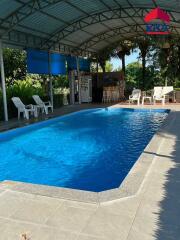 Covered outdoor swimming pool with seating