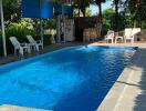 Covered outdoor swimming pool with seating