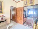 A well-decorated living area with wooden doors, framed art, and modern furnishings