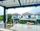 Spacious balcony with roof cover and view of neighboring houses