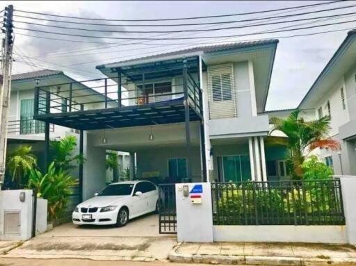 Two-story house with garage and garden