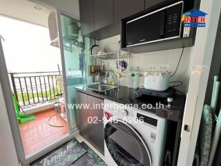 Compact kitchen with balcony view