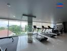 Indoor gym with exercise equipment and large windows with a view