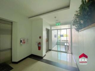 Building corridor with elevator and emergency exit sign