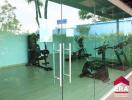 Glass-walled gym with various exercise equipment