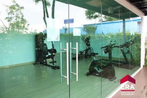 Glass-walled gym with various exercise equipment