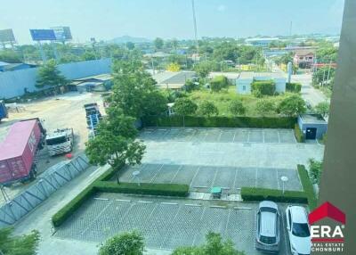 View of parking area from building with greenery