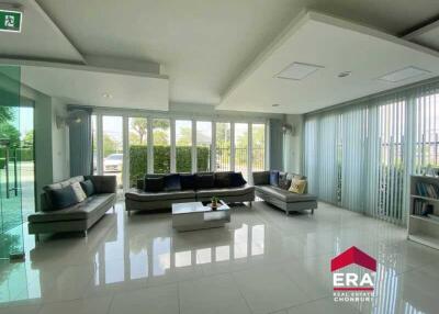 Spacious modern living room with large windows and comfortable seating