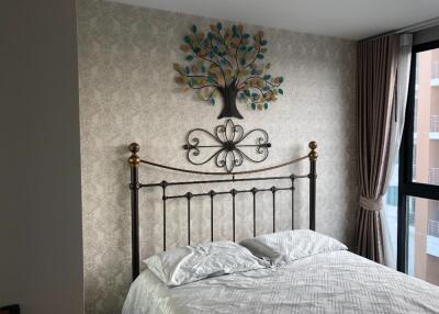 Decorative bedroom with metal framed bed and wall art