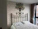 Decorative bedroom with metal framed bed and wall art