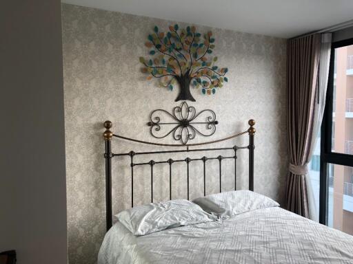 Decorative bedroom with metal framed bed and wall art