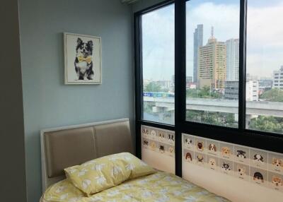Cozy bedroom with a large window and city view