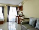 Modern studio apartment with bed, sofa, dining area, and large windows.