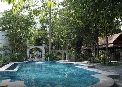 Outdoor swimming pool with garden and pavilion