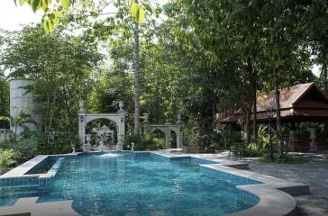 Outdoor swimming pool with garden and pavilion