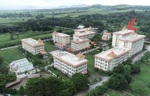 Aerial view of residential apartment complexes with surrounding greenery