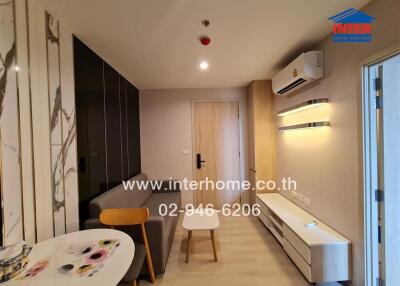 Modern living room with sofa, table, air conditioner, and cabinet