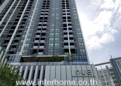 High-rise residential building exterior with real estate agency branding