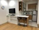 Modern kitchen with breakfast bar and TV