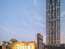 Modern high-rise building with illuminated signboard at dusk