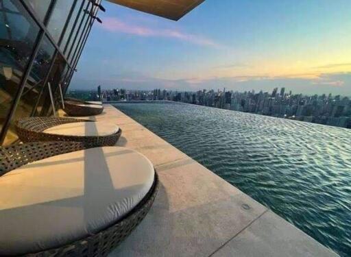 High-rise building rooftop infinity pool with cityscape view