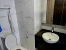 Modern bathroom with marble tiles and sleek fixtures