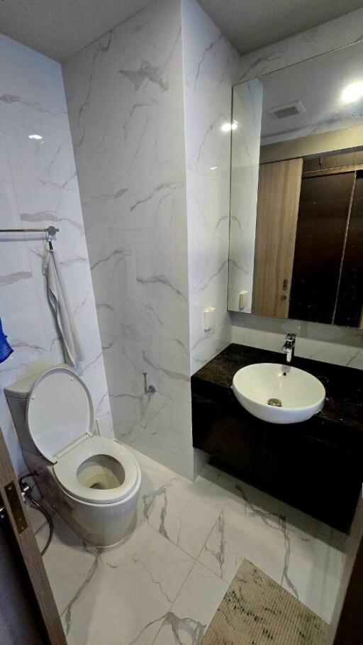 Modern bathroom with marble tiles and sleek fixtures