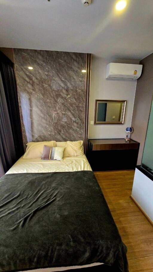 Bedroom with bed, mirror, and air conditioner