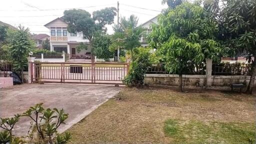 Front yard with gate and trees