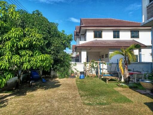 Spacious backyard with greenery and two-story house