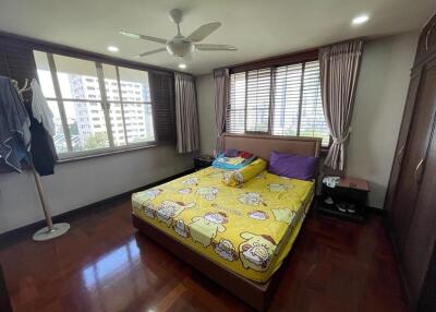 Bedroom with large windows and a ceiling fan