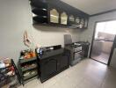 Modern kitchen with black cabinetry and stainless steel appliances