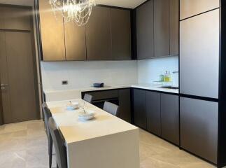 Modern kitchen with sleek cabinetry and a dining table