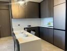 Modern kitchen with sleek cabinetry and a dining table