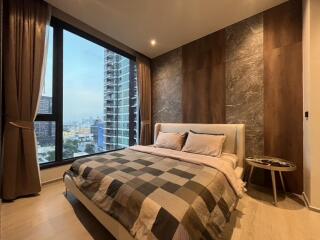 Modern bedroom with large windows and city view