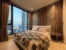 Modern bedroom with large windows and city view