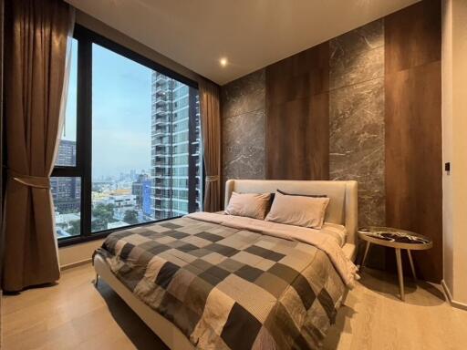 Modern bedroom with large windows and city view