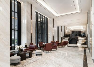 Modern luxury building lobby with seating area and staircase