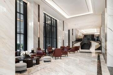 Modern luxury building lobby with seating area and staircase