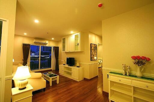 Well-lit living area with hardwood floors and modern furnishings