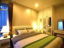 Cozy bedroom with double bed, bedside tables, lamps, mirrored wardrobe and window