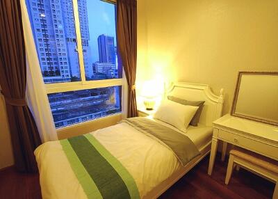 Bedroom with bed, nightstand, and mirror