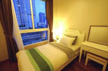 Bedroom with bed, nightstand, and mirror