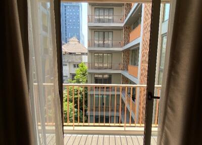 View from balcony showcasing surrounding buildings.