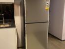 Modern kitchen with stainless steel refrigerator