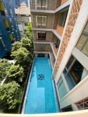 Outdoor swimming pool with surrounding apartments