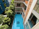 Outdoor swimming pool with surrounding apartments