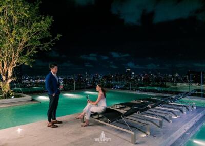 Rooftop swimming pool with city skyline view at night