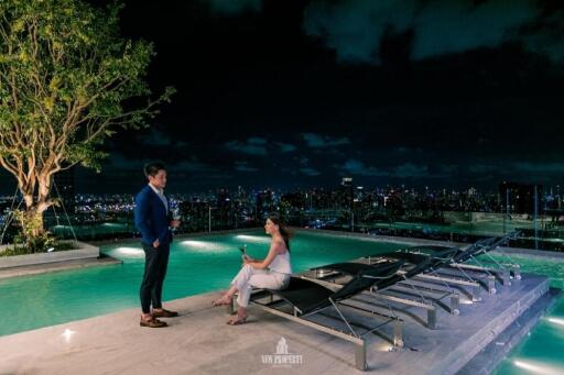 Rooftop swimming pool with city skyline view at night